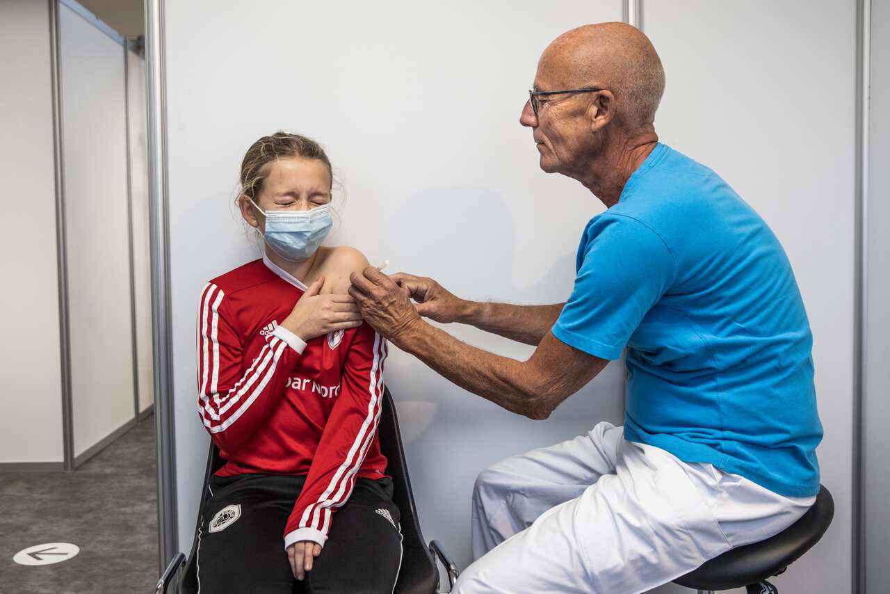 A child receives COVID-19 vaccination at Amager vaccination centre, Denmark, 28 November 2021. 