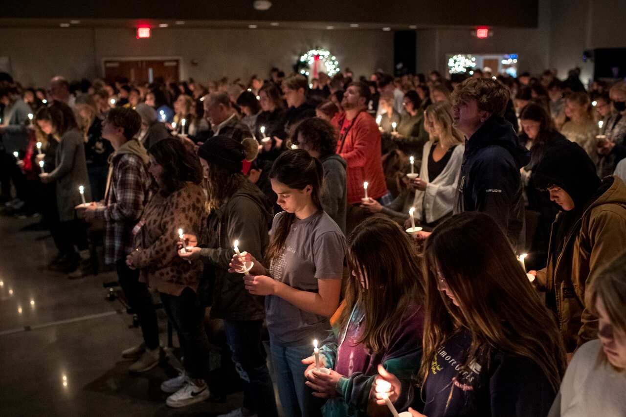 Members of the community attend a prayer service and candlelight vigil at Bridgewood Church in Clarkston, Michigan. 