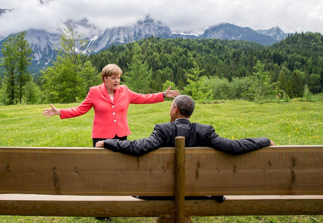 Angela Merkel talks to Mr Trump's predecessor Barack Obama during a G7 meeting at Elmau Castle in 2015