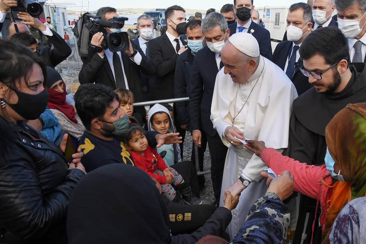 Pope Francis talks to people at the Reception and Identification Centre (RIC) in Mytilene on the island of Lesbos, Greece, 5 December 2021. 