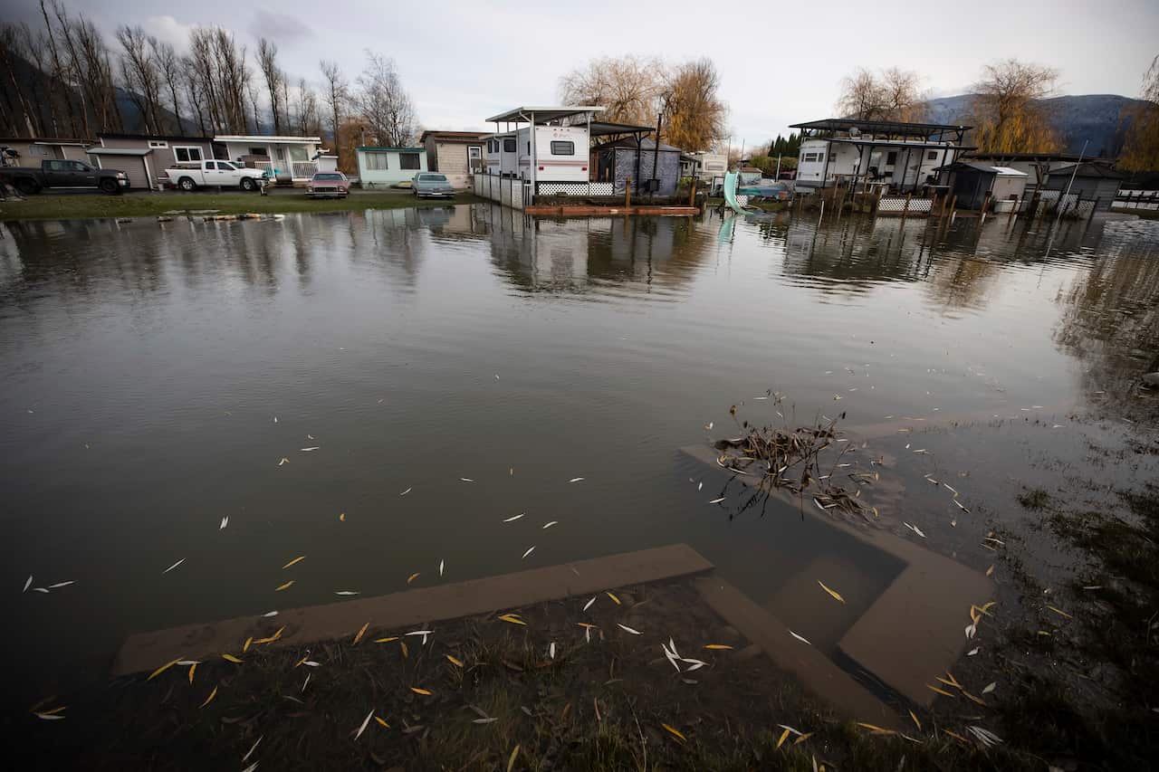 Properties are surrounded by high water after floodwaters began to recede at Everglades Resort on Hatzic Lake near Mission, B.C., on Sunday, December 5, 2021. (Darryl Dyck/The Canadian Press via AP)