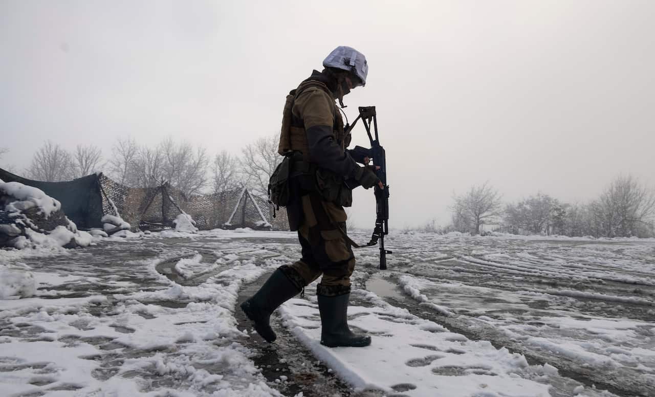 A Ukrainian soldier walks at the line of separation from pro-Russian rebels near Popasna in the Donetsk region, Ukraine