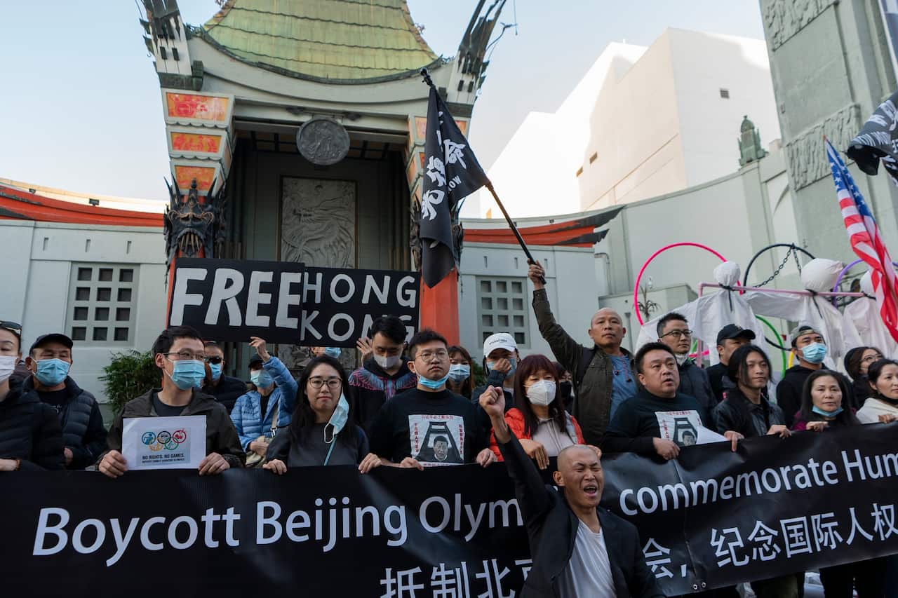 Demonstrators hold a rally to protest the Beijing 2022 Winter Olympic Games on International Human Rights Day outside the TCL Chinese Theatre in the Hollywood district of Los Angeles, Friday, Dec. 10, 2021. (AP Photo/Damian Dovarganes)