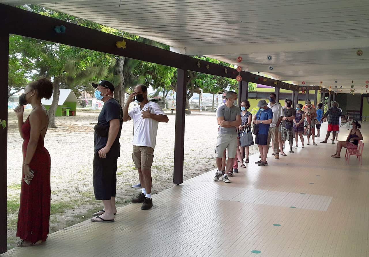 People gather at a polling station in Noumea