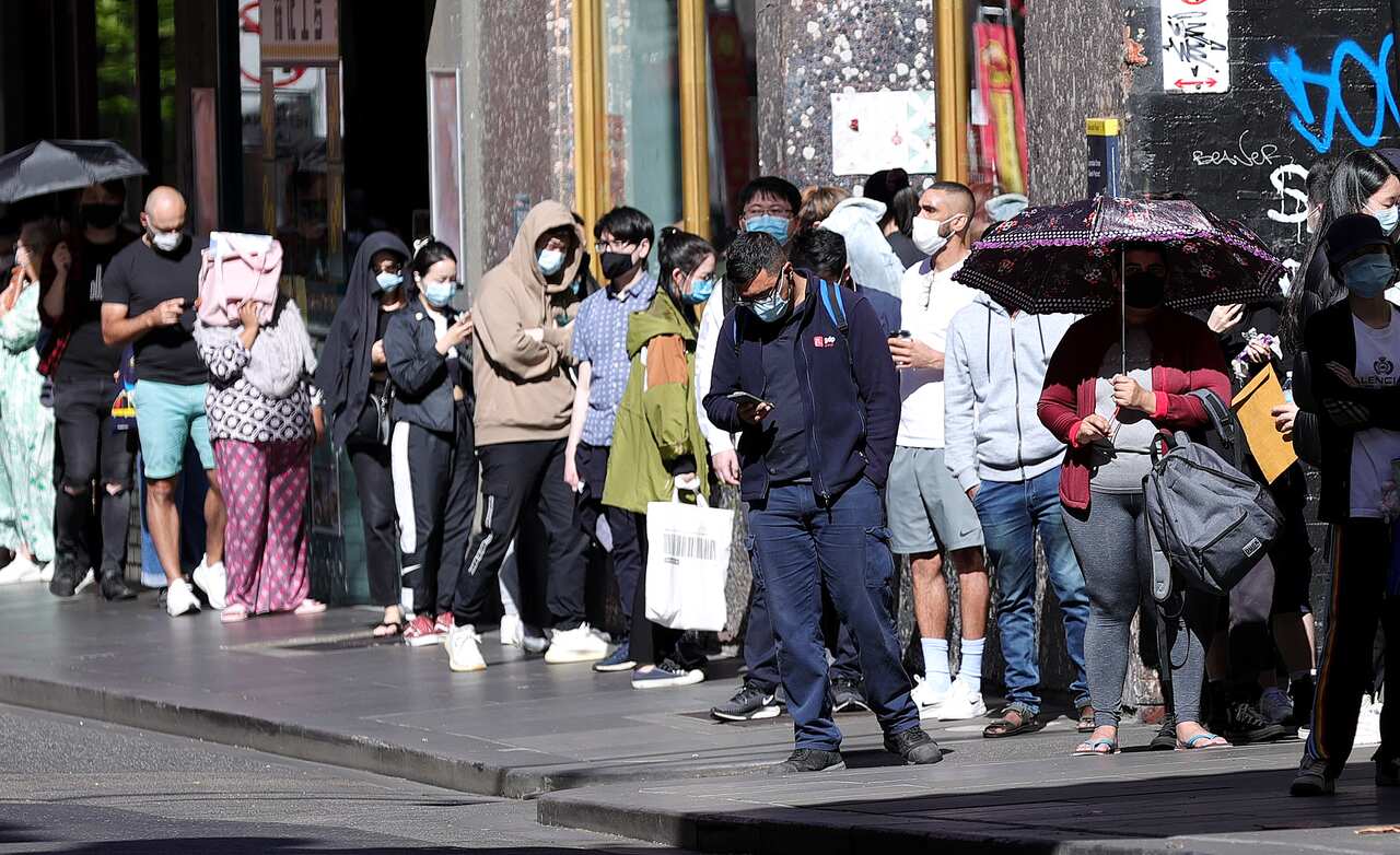 People are seen in a queue at the Russell Street testing clinic in Melbourne, Monday, December 20, 2021. 