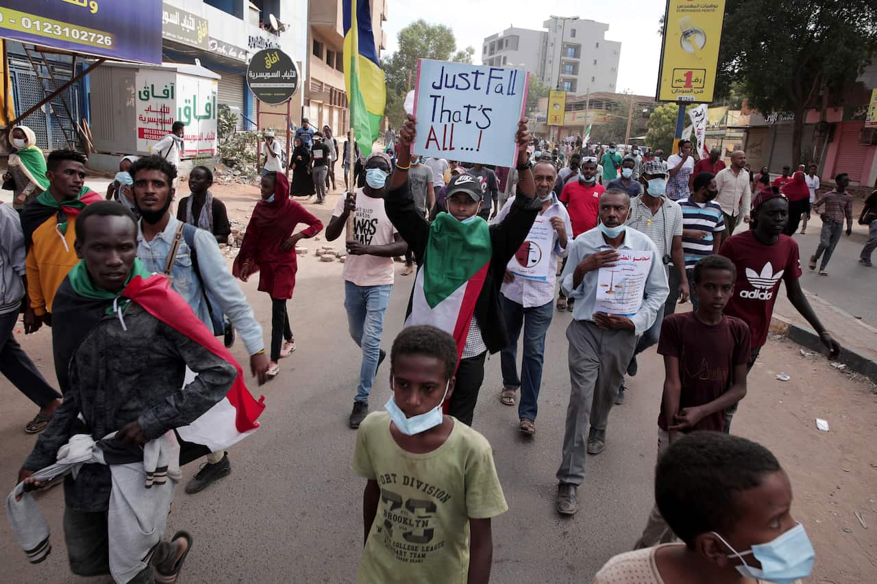 People march during a protest to denounce the October military coup