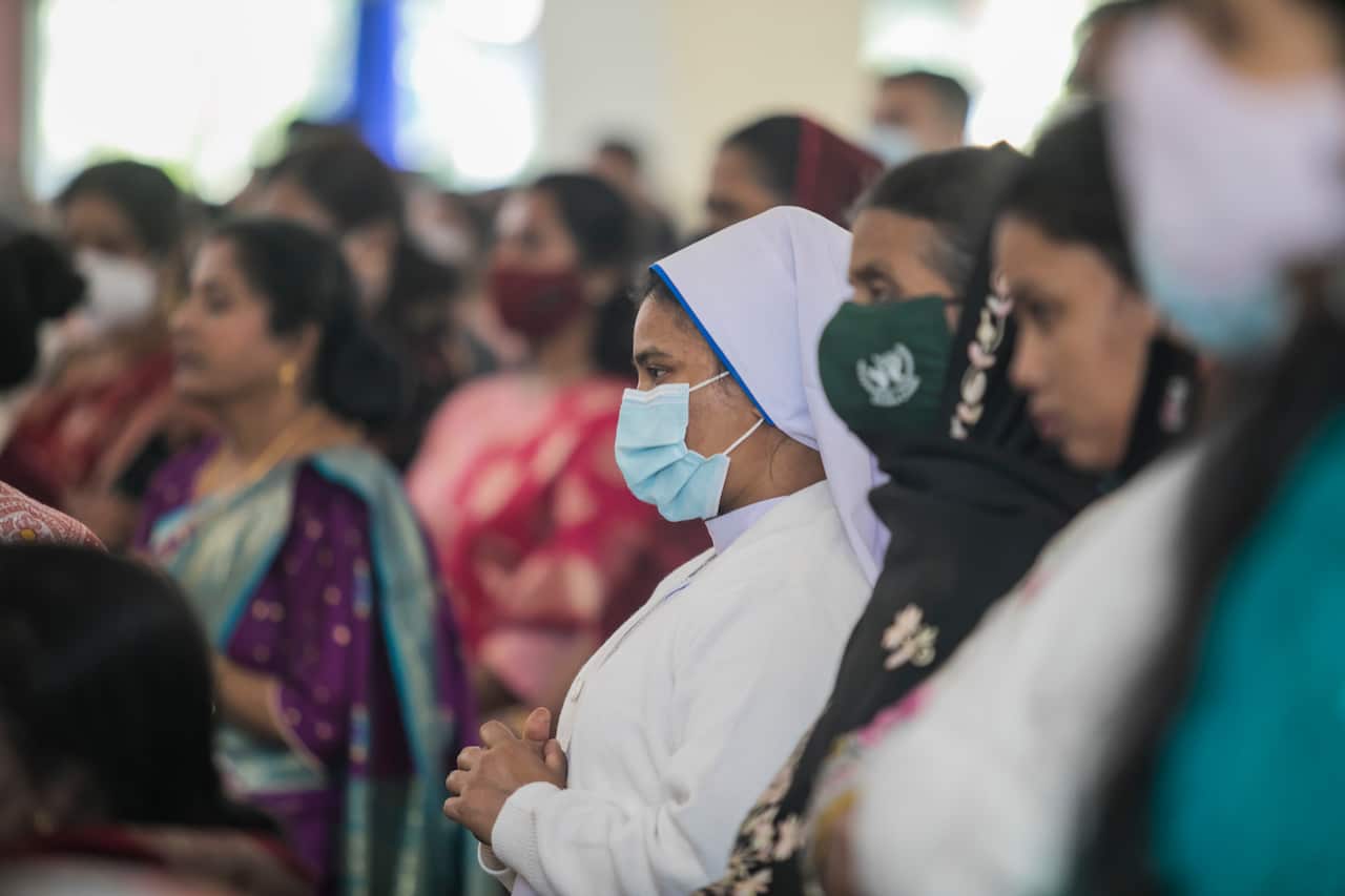 Christian Devotees wearing masks attend prayers at a Holy Rosary Catholic Church during Christmas.
