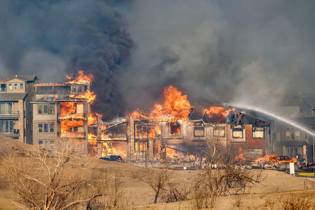 In the old town area of Superior, Colorado, multiple buildings and vehicles are on fire