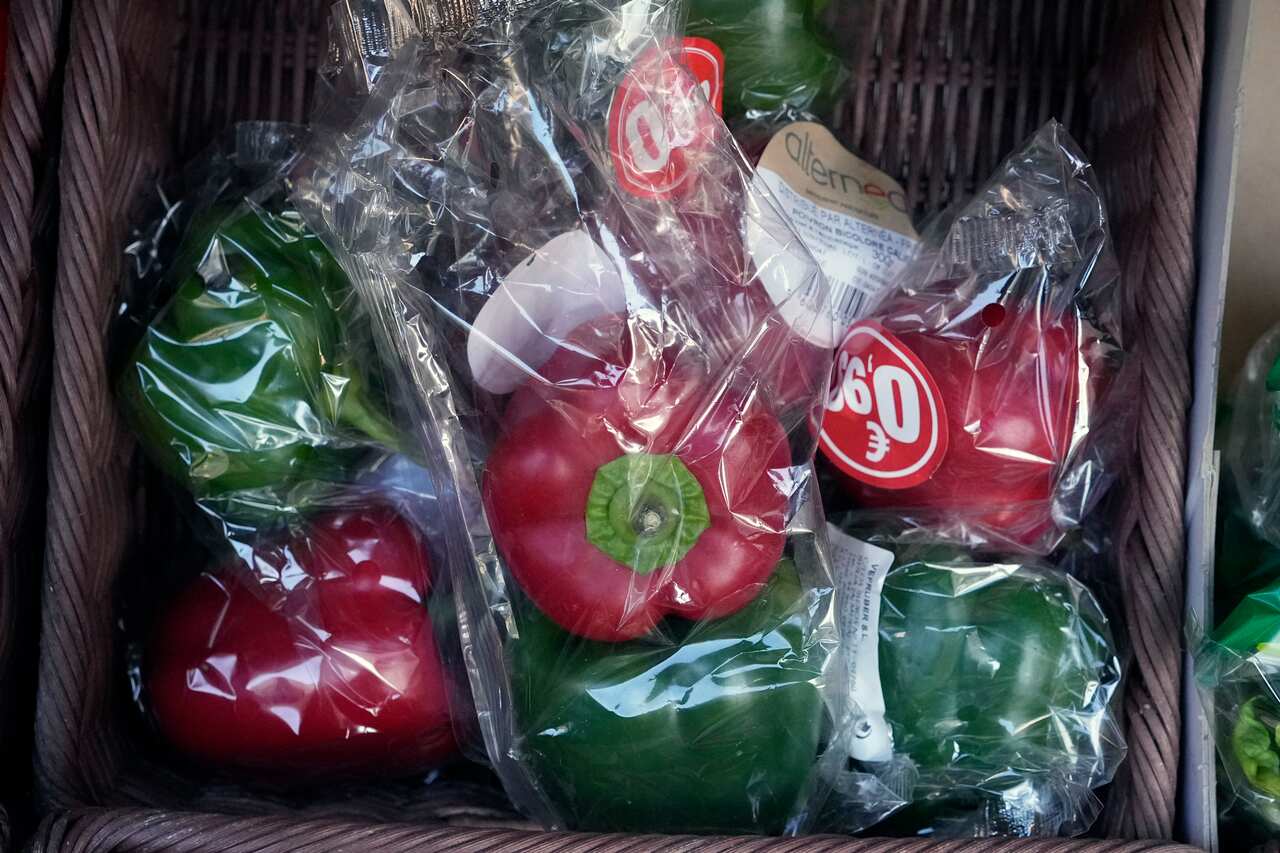 Capsicums wrapped in plastic package are on display on a grocery stall in Paris, Friday, 31 December, 2021. 