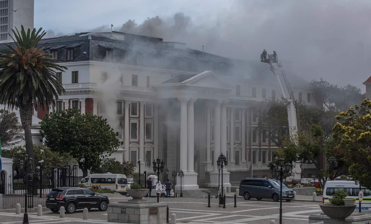 Smoke billowing from a building at the South African Parliament precinct in Cape Town, South Africa, 2 January 2022.
