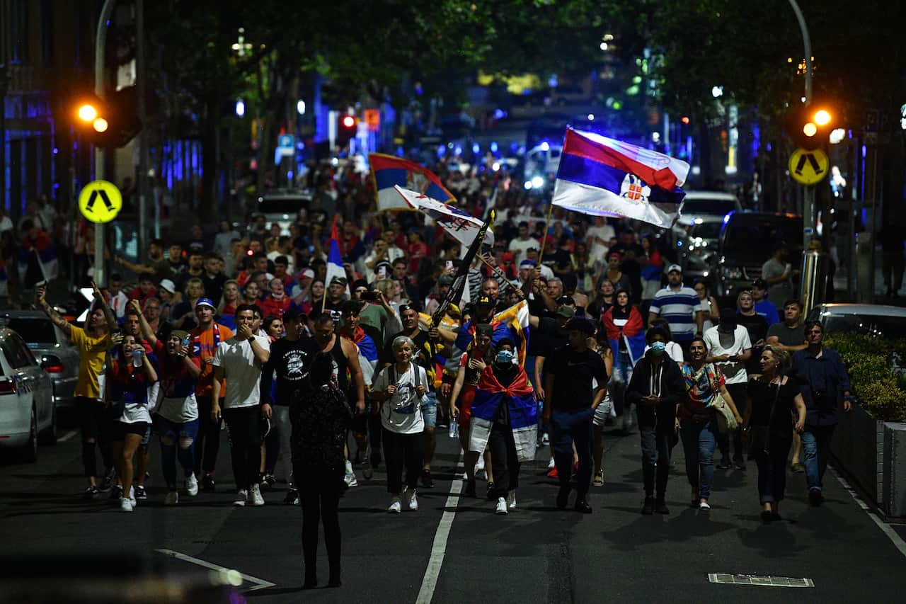 Members of the Serbian community are seen marching in Melbourne, Monday, January 10, 2022. Novak Djokovic will be freed from immigration detention after an order by the Federal Circuit Court. (AAP Image/James Ross) NO ARCHIVING