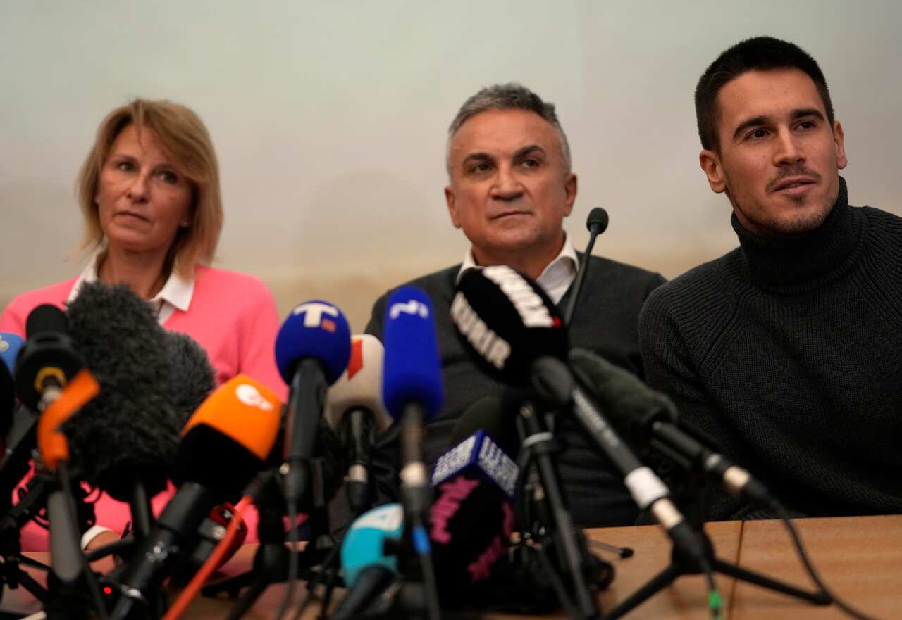 Serbia's Novak Djokovic's father Srdjan, center, brother Djordje, right, and mother Dijana attend a press conference in Belgrade, Serbia, Monday, Jan. 10, 2022. Tennis star Novak Djokovic on Monday won a court battle to stay in Australia to contest the Au