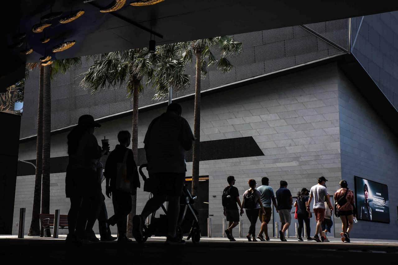 People are seen walking through Darling Harbour, Sydney