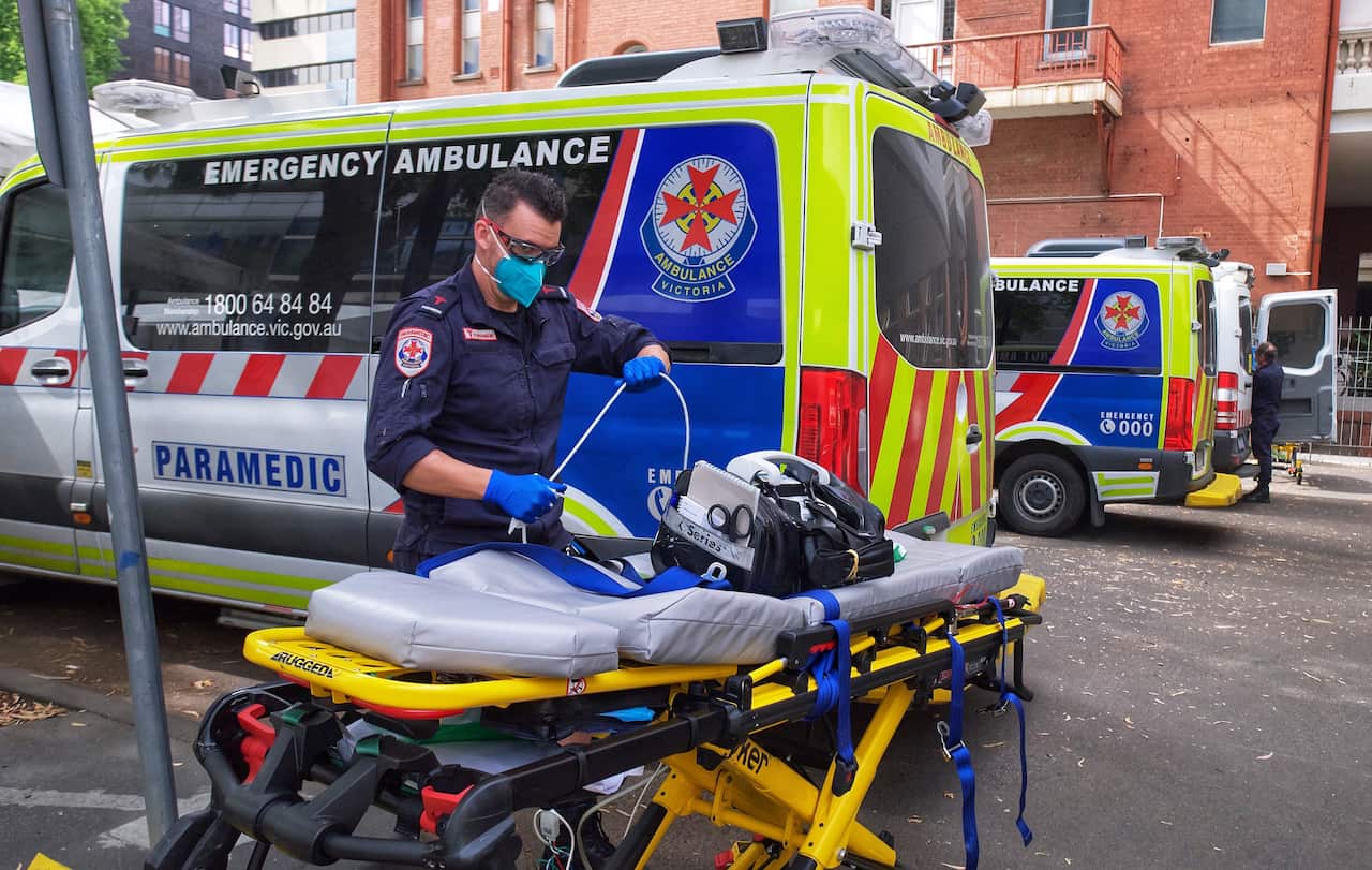 A paramedic moving equipment outside St. Vincent's Hospital in Melbourne.