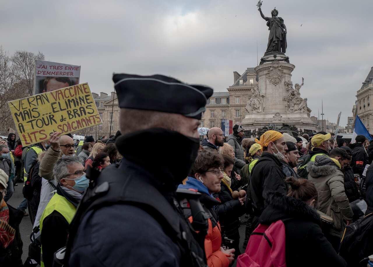 Demonstrators, in opposition to vaccine pass and vaccinations to protect against COVID-19 during a rally in Paris, France, Saturday, Jan. 22, 2022. (AP Photo/Rafael Yaghobzadeh)(AP Photo/Rafael Yaghobzadeh)