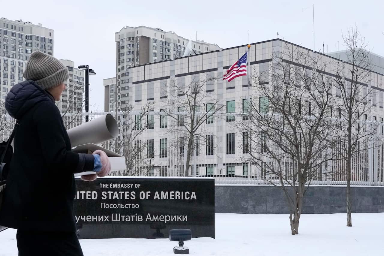 A woman walks past the US Embassy in Kyiv, Ukraine, 24 January 2022.