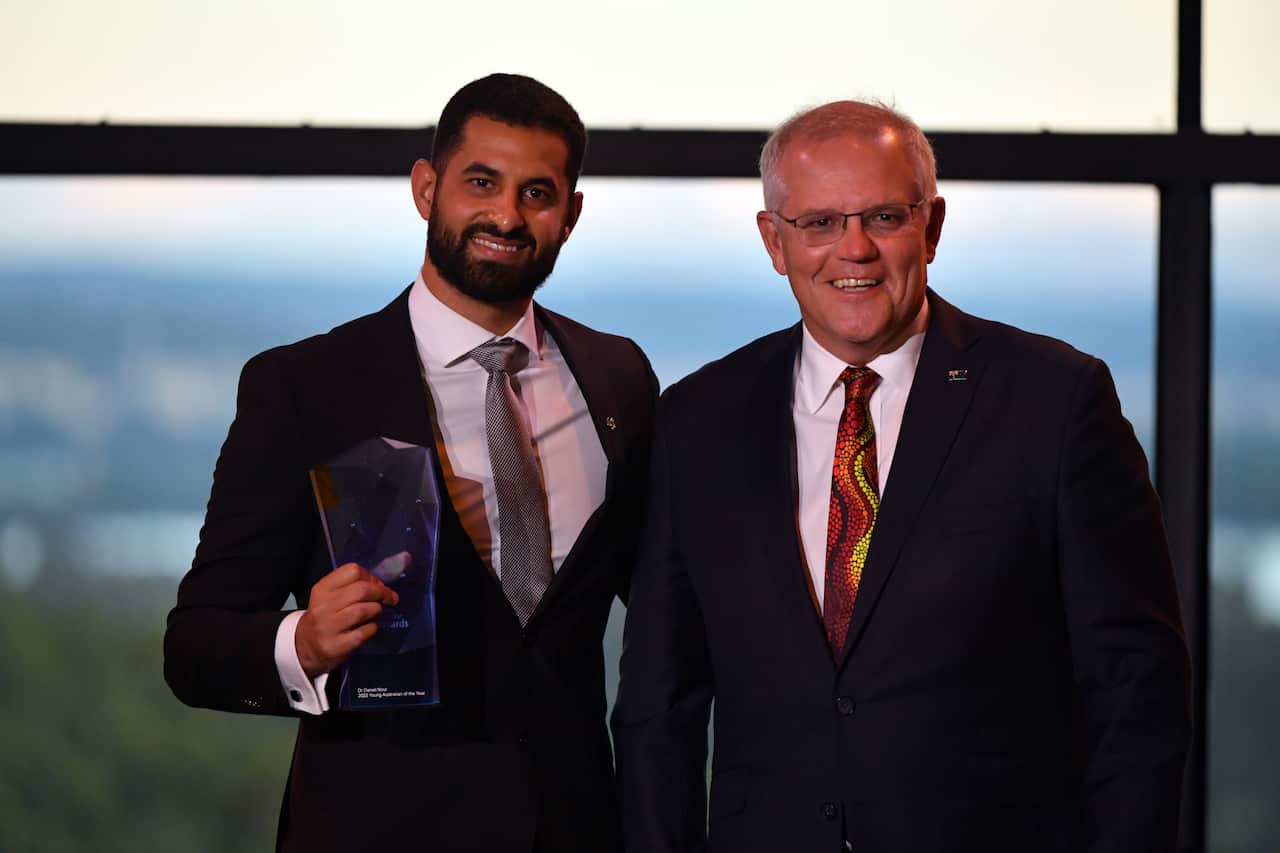 Prime Minister Scott Morrison and 2022 Young Australian of the Year Dr Daniel Nour winner during the 2022 Australian of the Year Awards ceremony, at the National Arboretum in Canberra, Tuesday, January 25, 2022. (AAP Image/Mick Tsikas) NO ARCHIVING