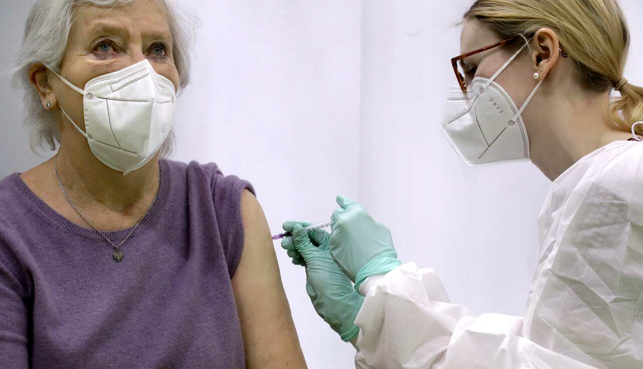 Renate Schulz, left, receives a 'Moderna COVID-19' vaccination by doctor Laura Tosberg,