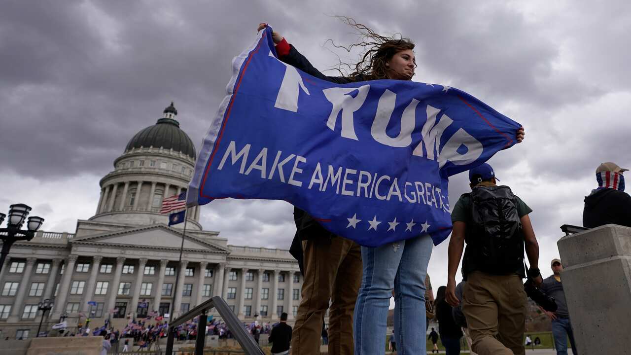 A Donald Trump supporter waves a flag