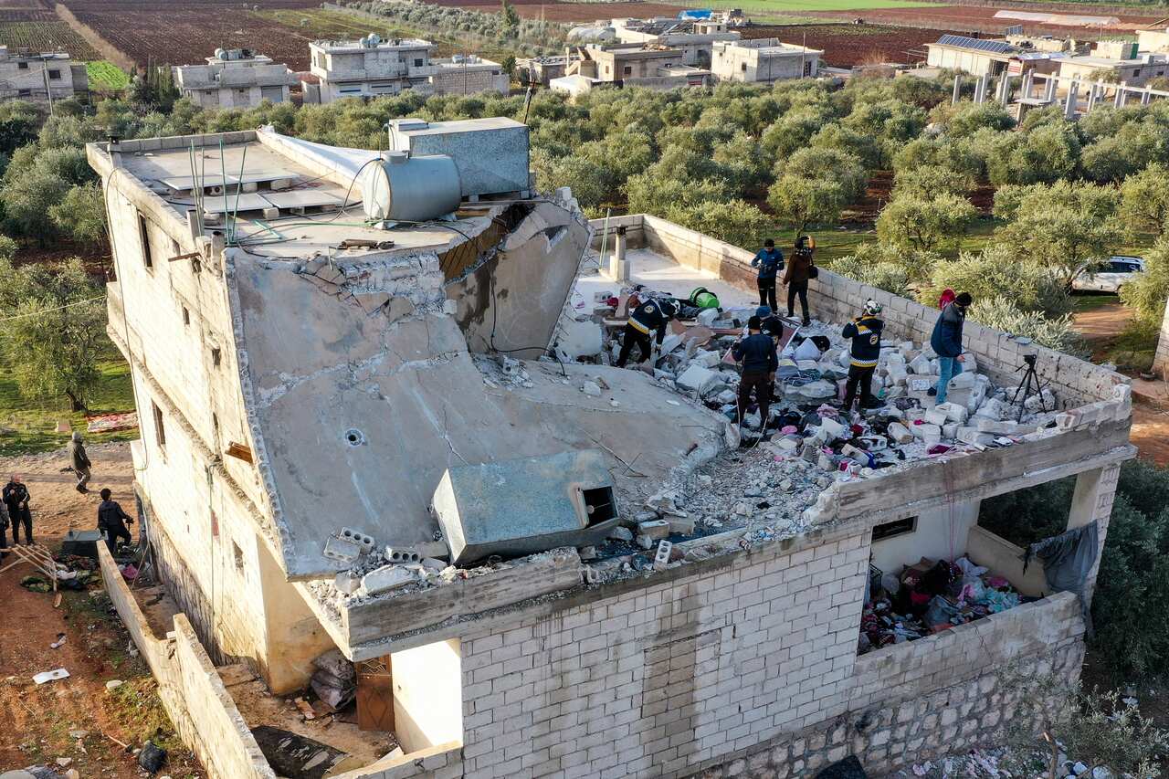 People inspect a destroyed house following an operation by the U.S. military in the Syrian village of Atmeh, in Idlib province, Syria