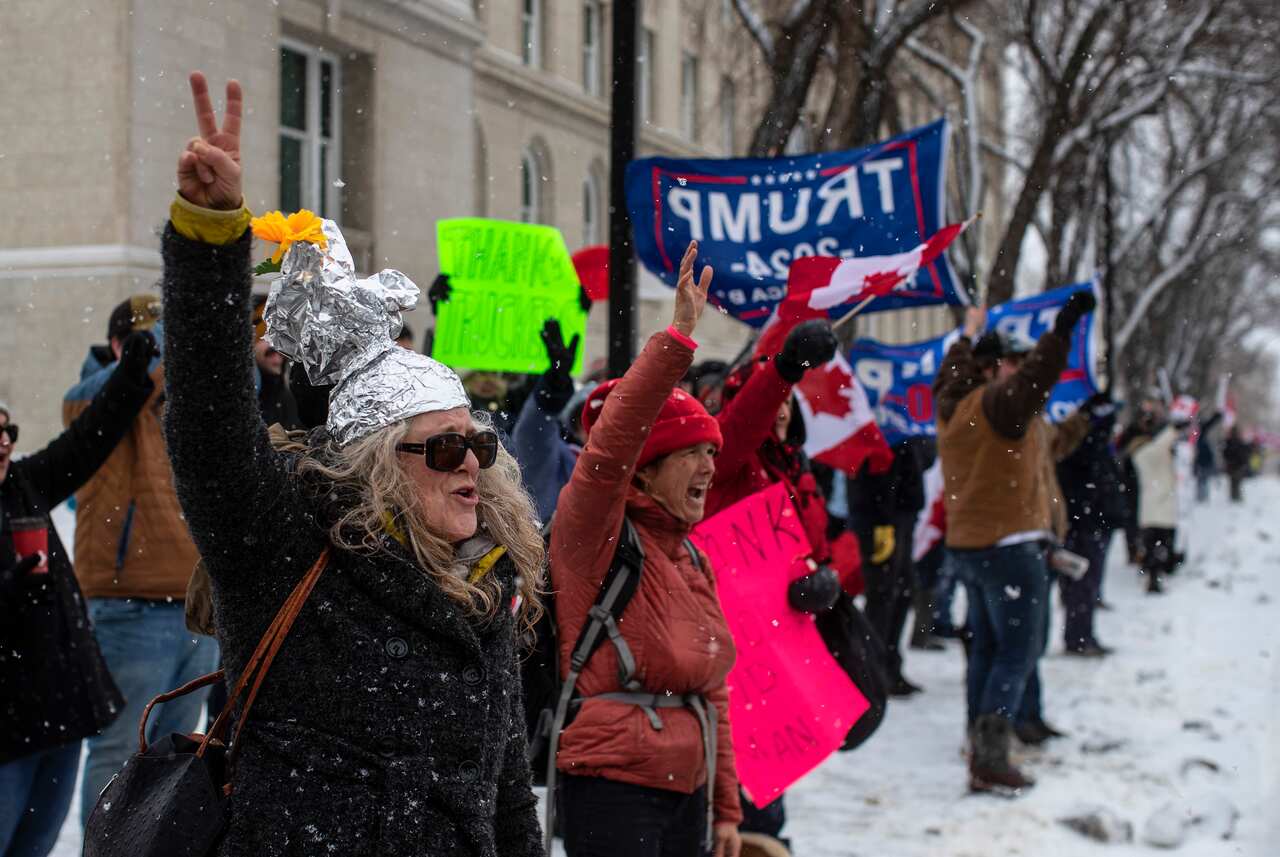 People gather in protest against COVID-19 mandates and in support of a protest against COVID-19 restrictions taking place in Ottawa, in Edmonton, Alberta, Saturday, Feb. 5, 2022. (Jason Franson/The Canadian Press via AP)