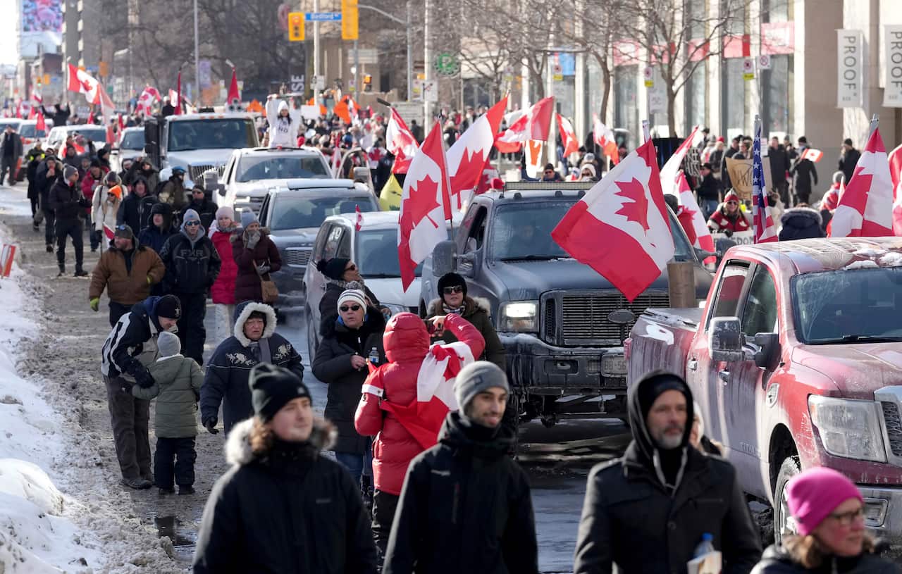 Trucks and supporters travel down Bloor Street during a demonstration in support of a trucker convoy in Ottawa