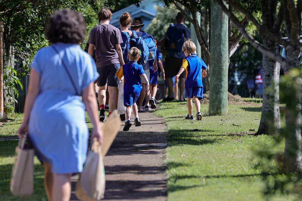 Students enter school grounds for their first day back of the year in Brisbane, Monday, 7 February 2022.