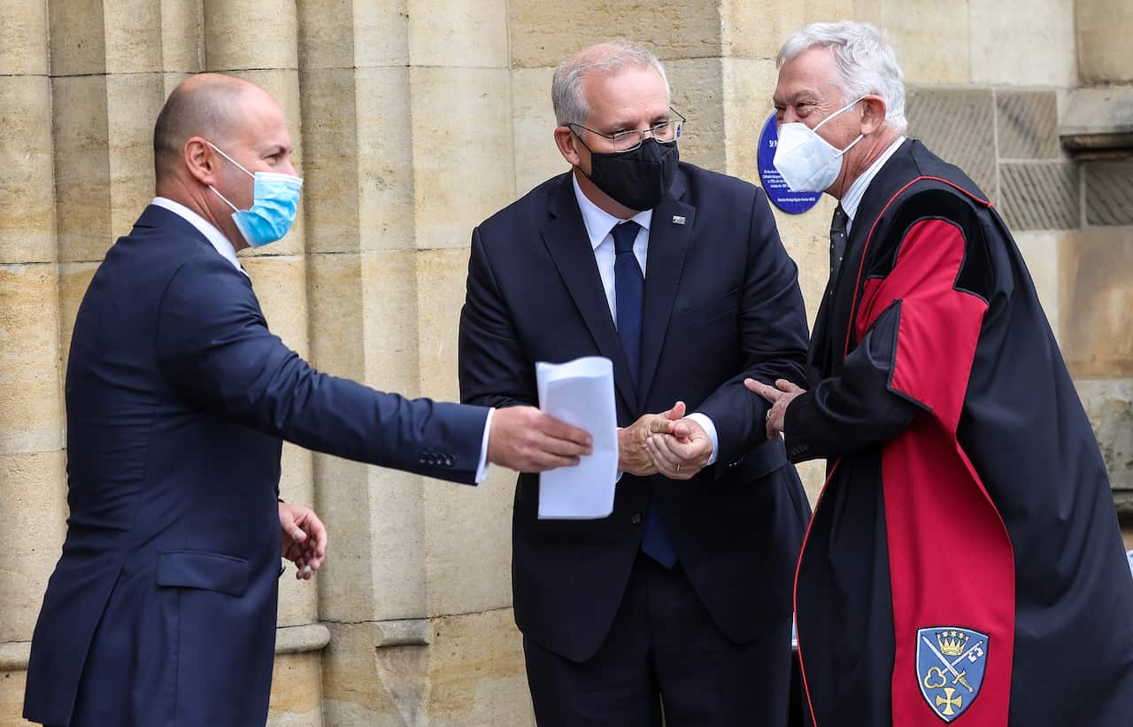 Treasurer Josh Frydenberg (left) and Prime Minister Scott Morrison arrive to the State Memorial Service for Andrew Peacock at St Paul’s Cathedral in Melbourne, Friday, February 11, 2022. (AAP Image/Pool, Ian Currie) NO ARCHIVING