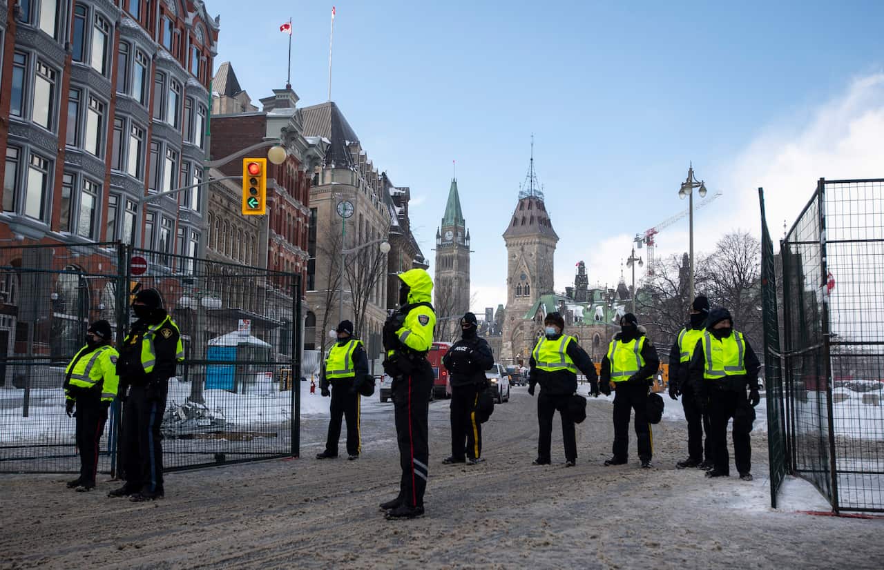 Police at a gate along Queen Street