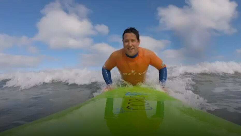 Paraplegic Scott Crowley surfs.