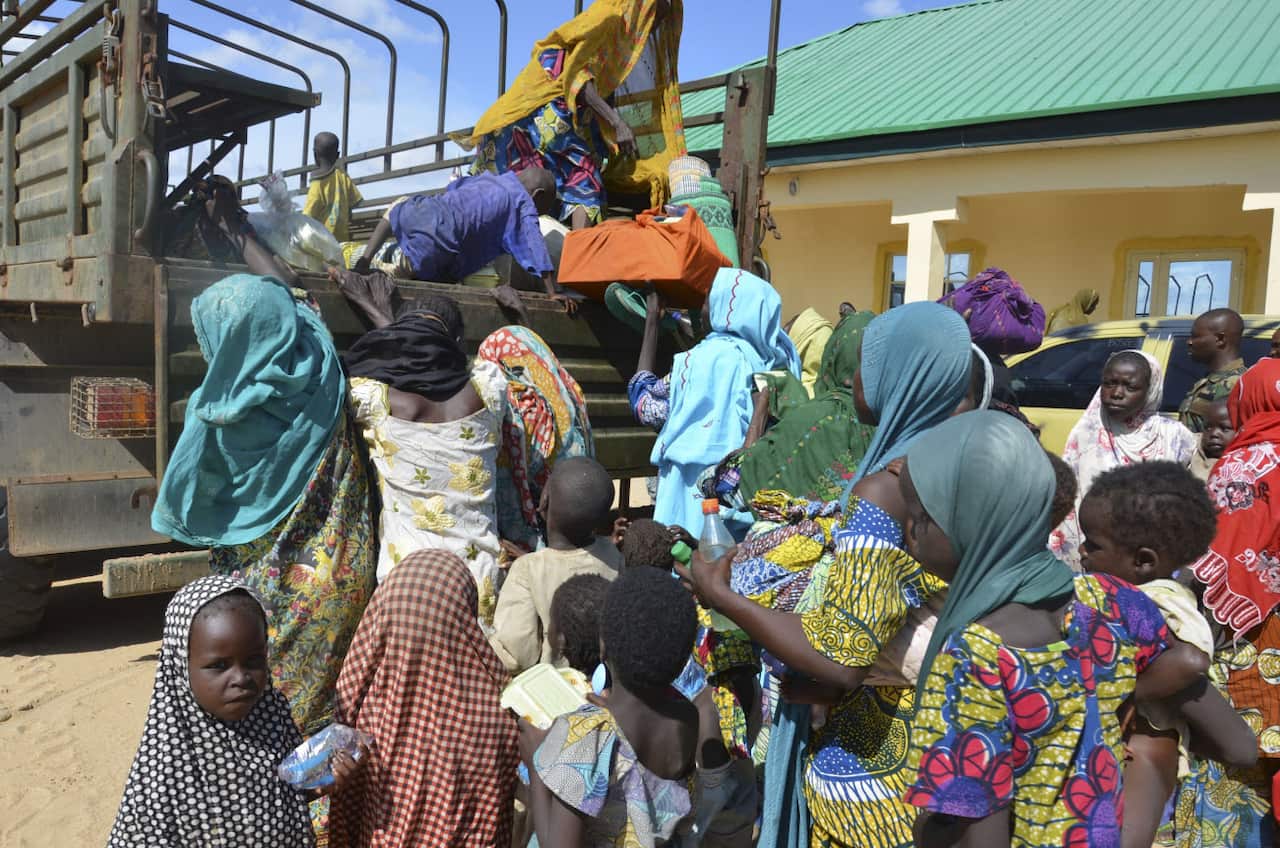 Women and children rescued by Nigerian soldiers from Boko Haram extremists in northeast Nigeria arrive at the military office in Maiduguri