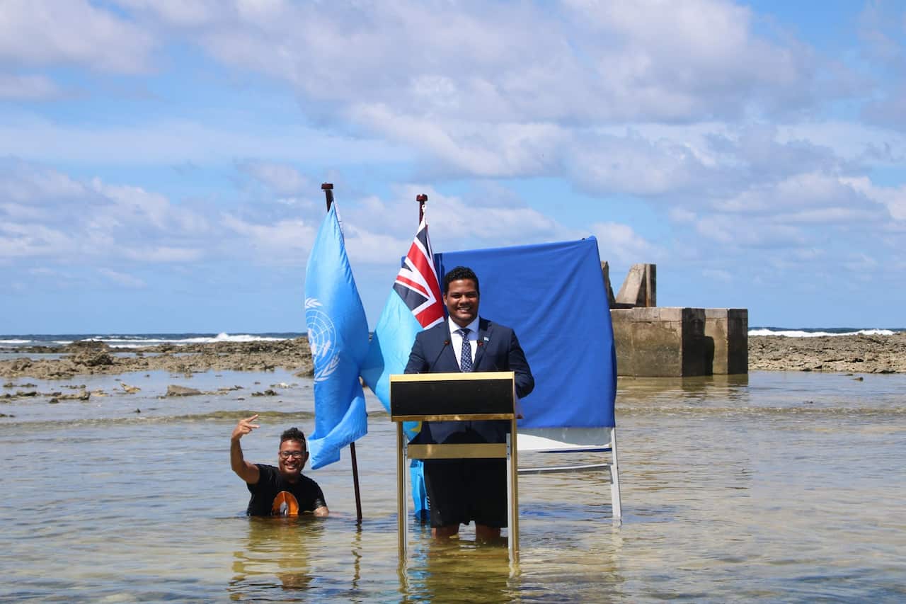 Tuvalu leader Simon Kofe films his COP26 address knee deep in water.