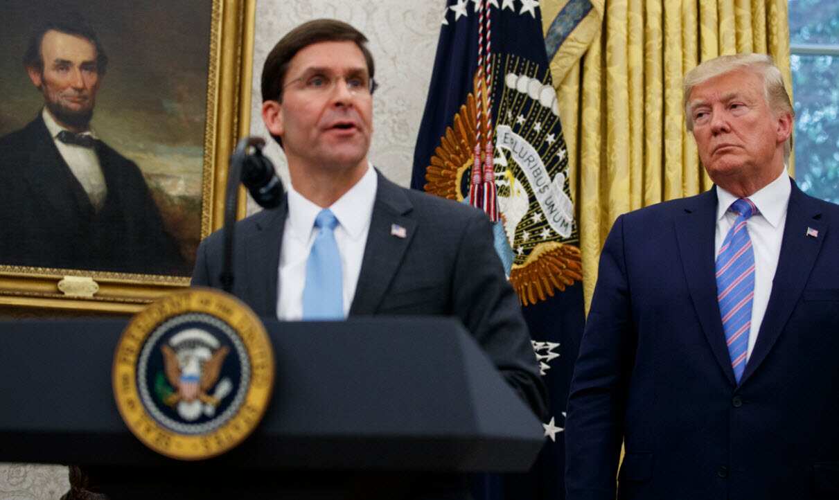 President Donald Trump looks to Secretary of Defense Mark Esper during a ceremony in the Oval Office at the White House in Washington, July, 2019. 