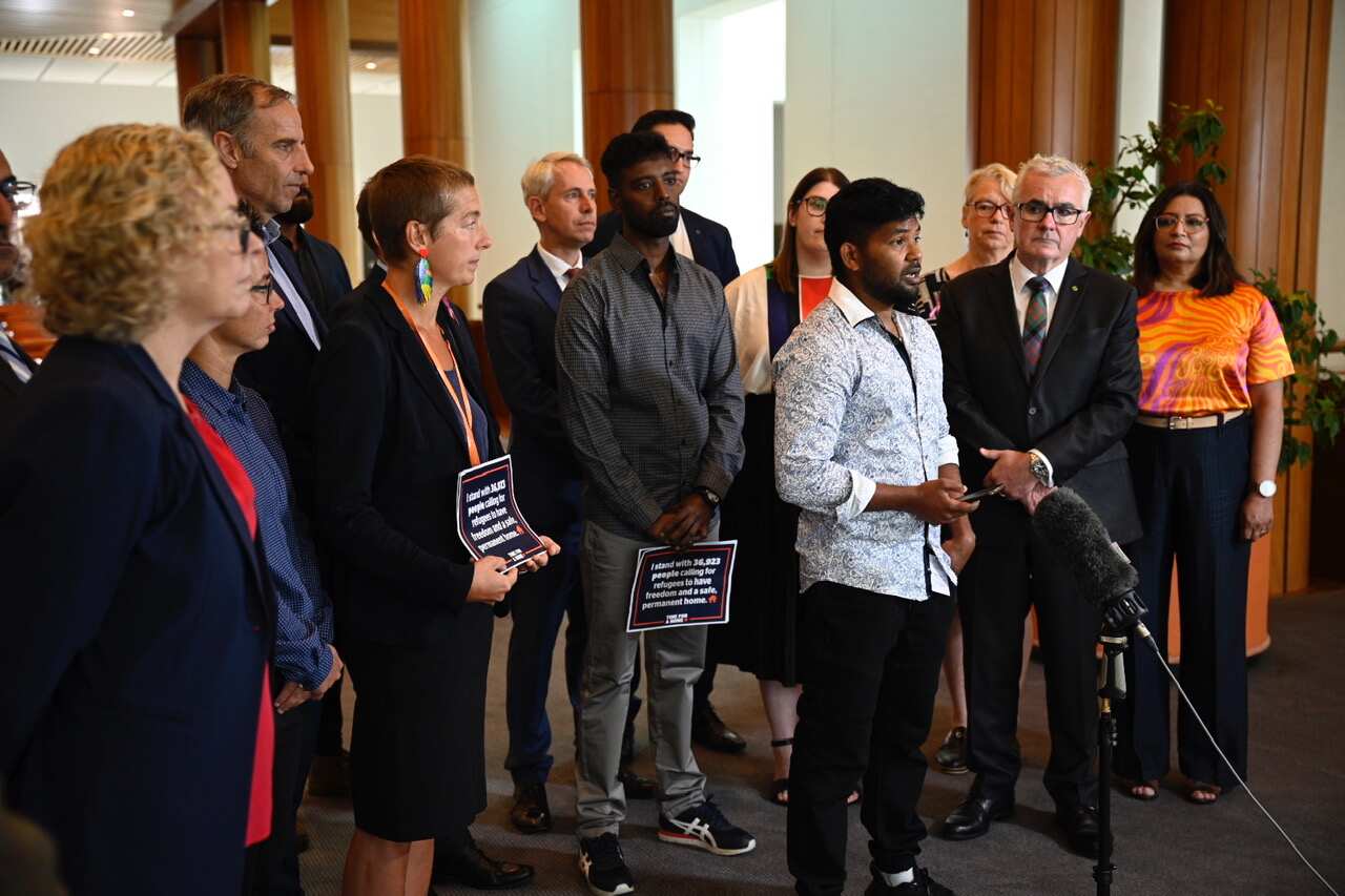 Refugee Thanush Selvarasa at Parliament House in Canberra with advocacy groups and politicians..