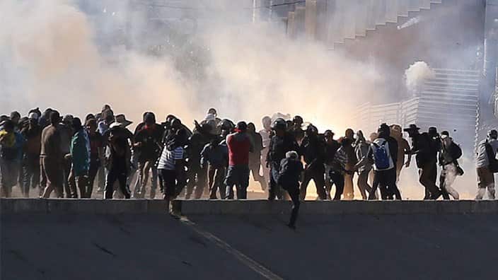 US agents launched gas canisters at migrants attempting to breach the border fence with Mexico. 