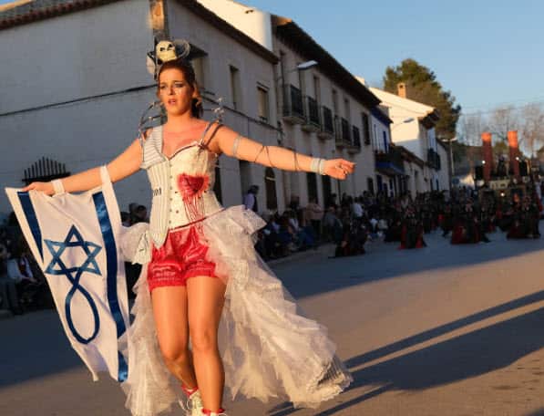A woman with an Israeli flag is seen in a Holocaust-themed parade during Carnival festivities on February 24, 2020 in Campo de Criptana, Spain