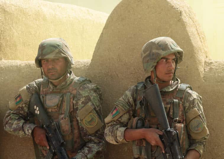 Officer cadets training to fight in a village.