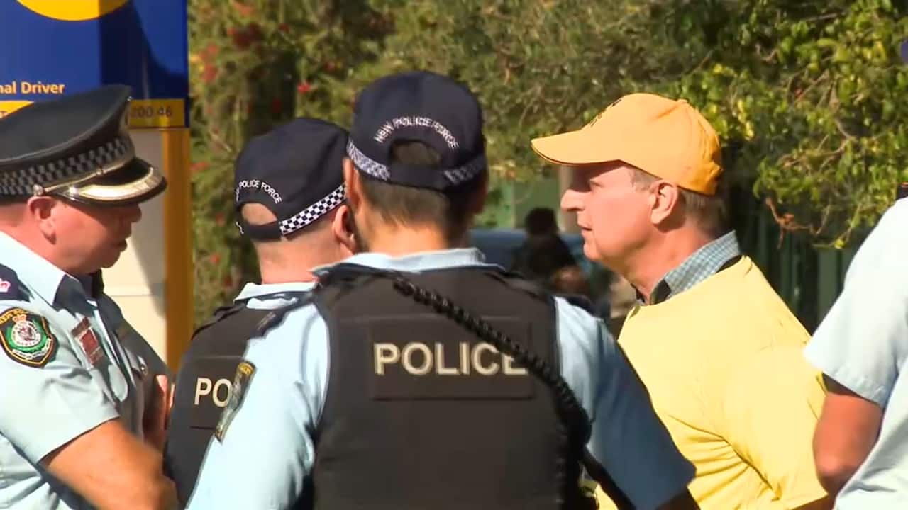 The man talks with police.