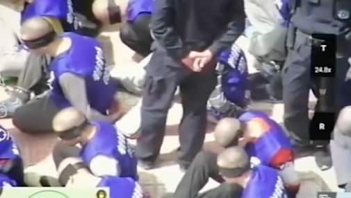 On the backs of the men in the video is  the words 'Kashgar City Detention Centre'.