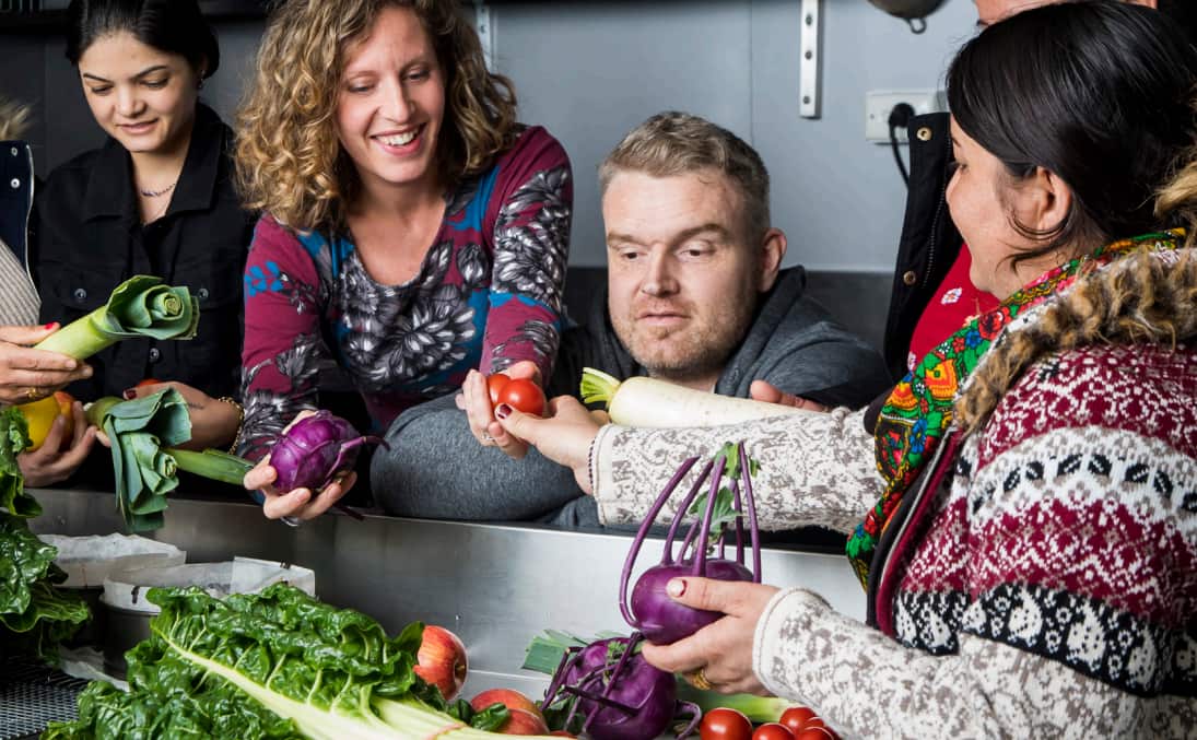 Refugees and community members prepare for the pop-up.
