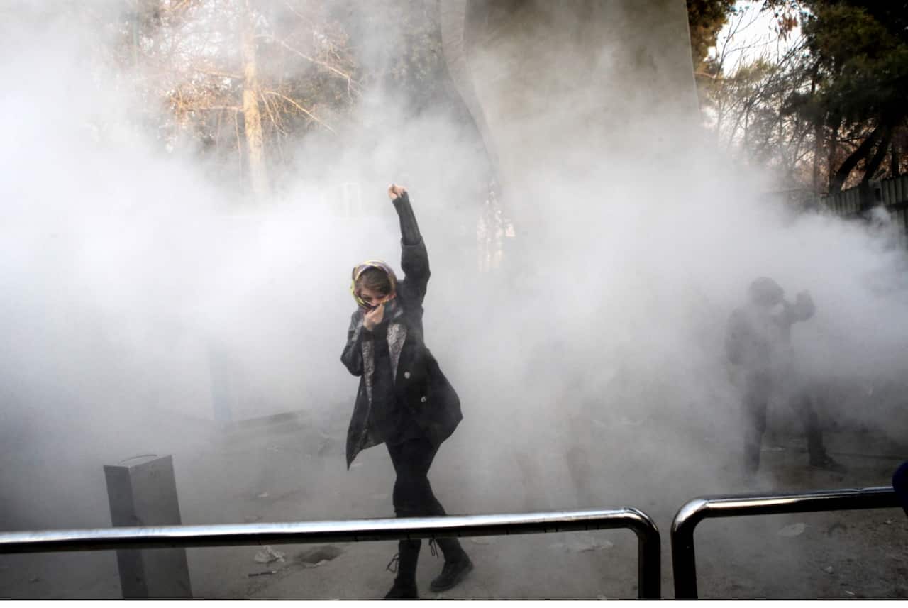 Iranian students clash with riot police during an anti-government protests around the Tehran University in Tehran, Iran 