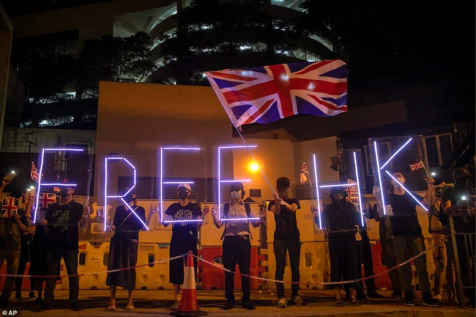Demonstrators wave a British flag during a rally outside of the British Consulate in Hong Kong.