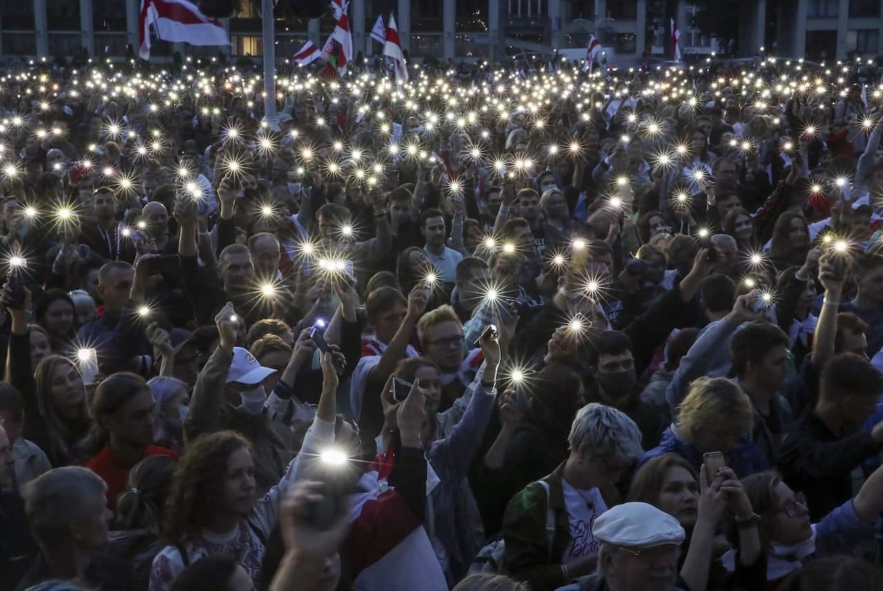 MINSK, BELARUS - AUGUST 25, 2020: People use their mobile phone torches during an opposition rally in Independence Square.