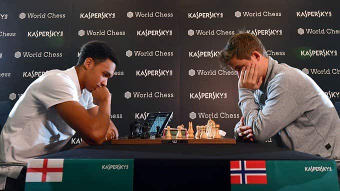 Liverpool Trent Alexander-Arnold (L) takes on World Chess champion Magnus Carlsen.