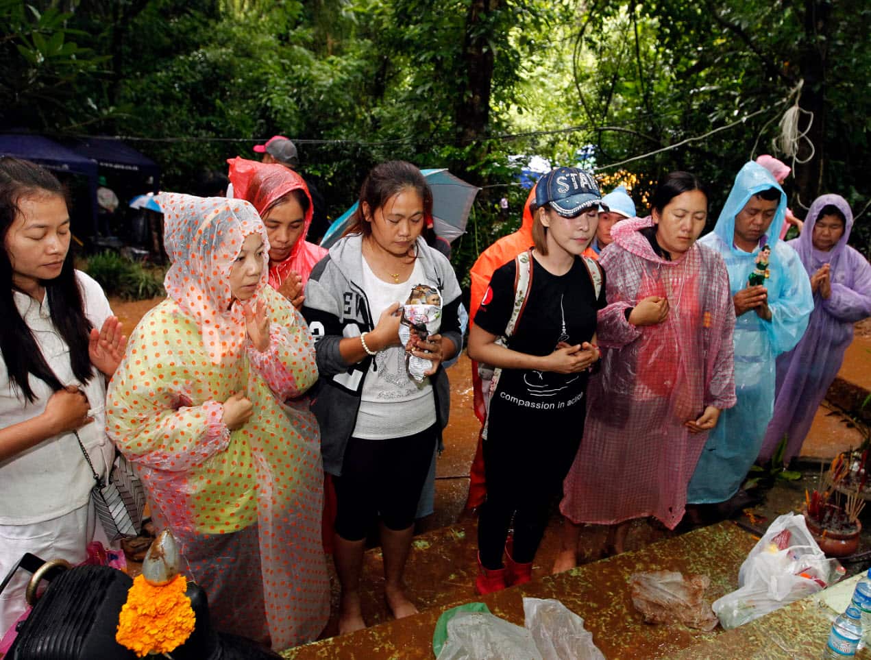 Women pray near the Tham Luang Nang Non cave complex in northern Thailand