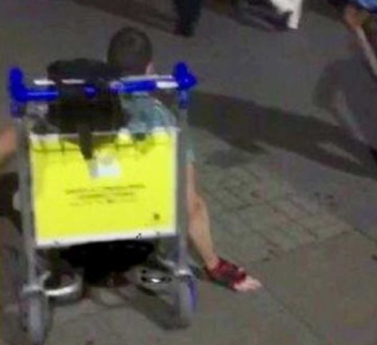 Justin Levene on a luggage trolley.