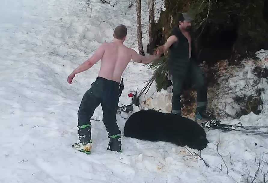 The pair high-five after killing the mother bear.