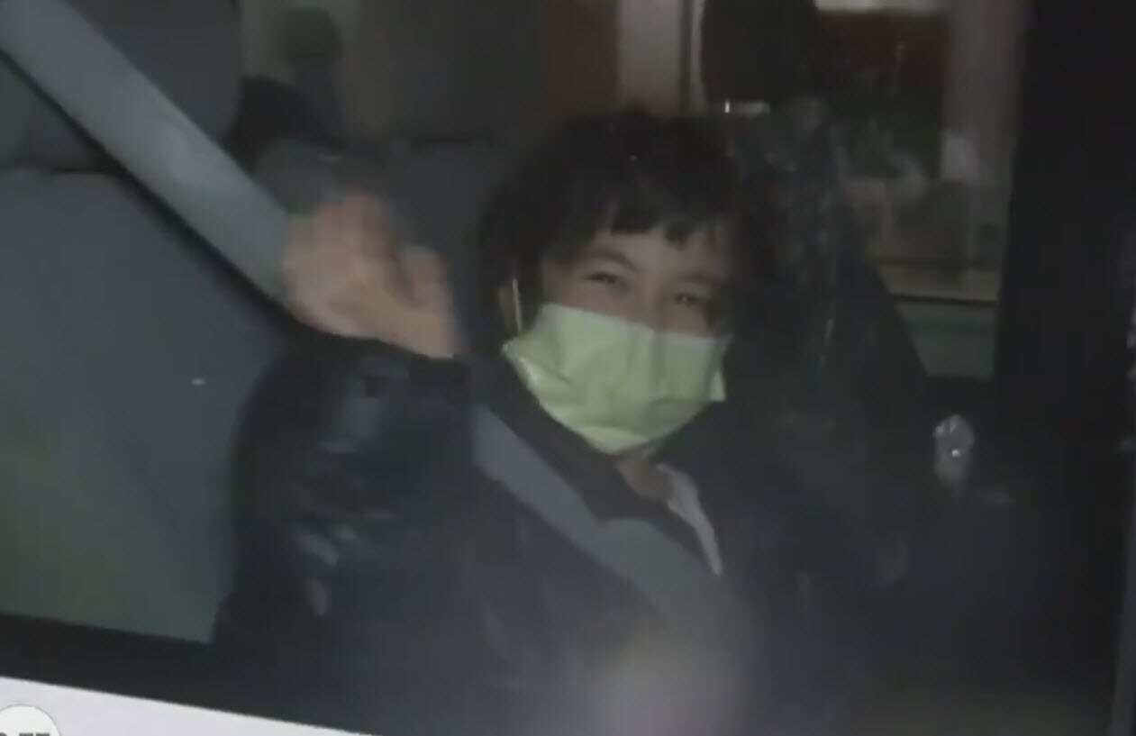 A woman seen smiling and waving after having been evacuated to Christmas Island from the coronavirus epicentre of Wuhan in China.