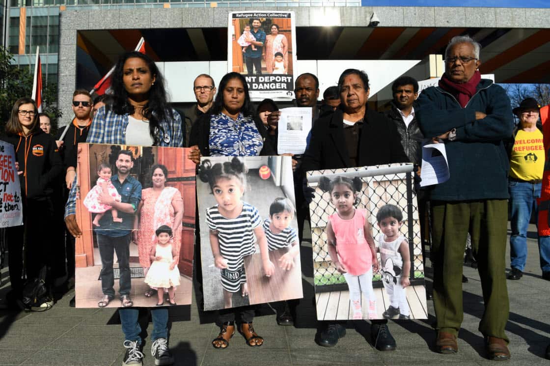 Supporter's of the Biloela Tamil asylum seeker family gather outside of the Federal Court in Melbourne.