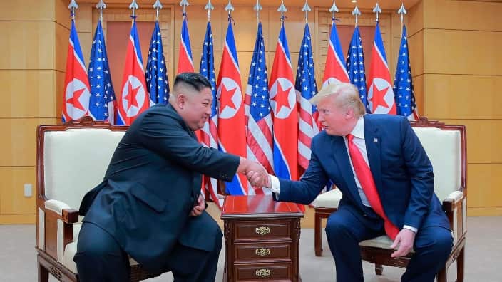 North Korean leader Kim Jong-un and US President Donald Trump shake hands.